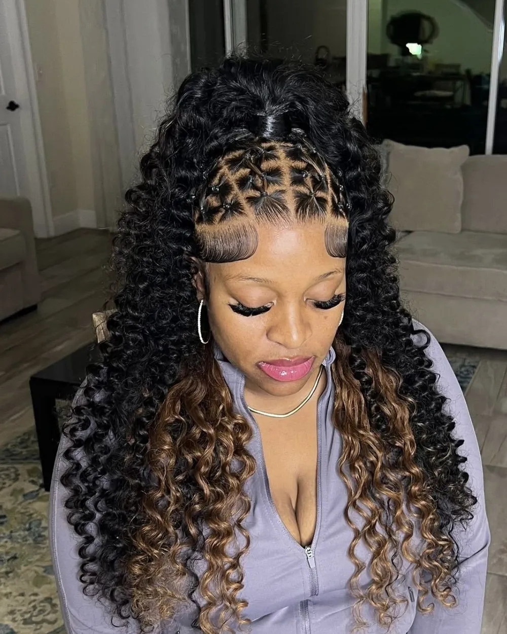 Woman with half-up boho braids and honey highlights