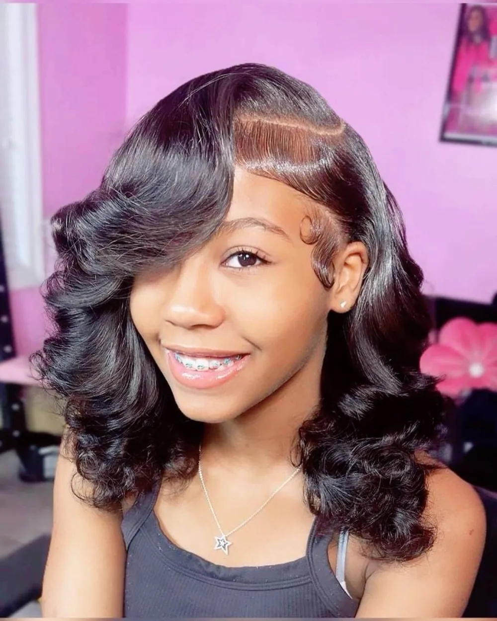 Smiling woman with a curled bob and swoop bangs