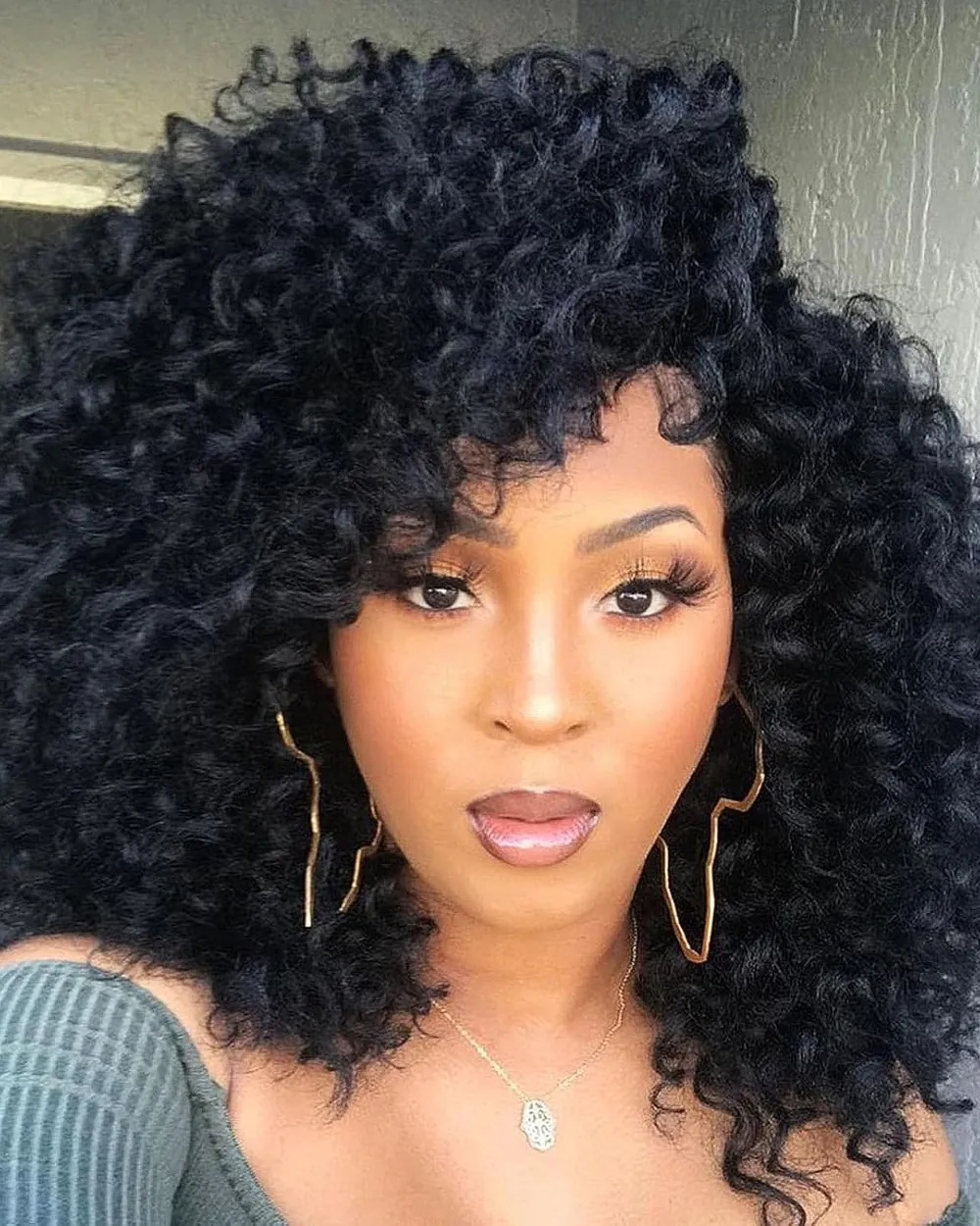 Woman with a full head of bouncy black crochet curls