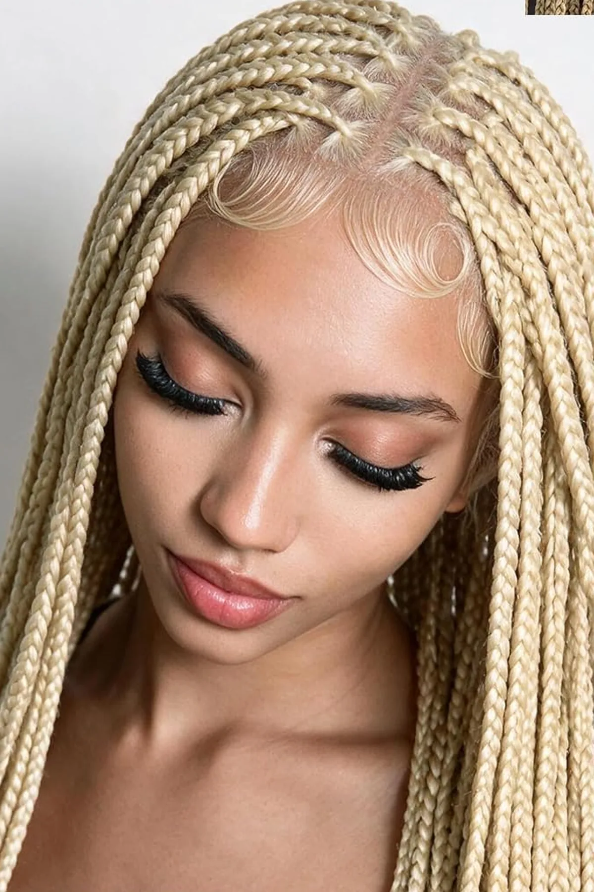 Woman with long blonde knotless braids